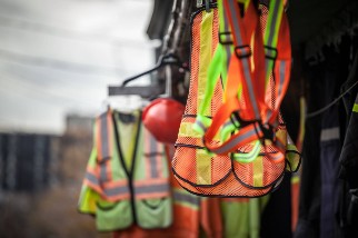PPE hanging on hooks outdoors at a construction site
