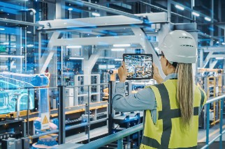 Safety-professional-woman-using-augmented-technology-to-assess-a-manufacturing-fSafety professional woman using augmented technology to assess a manufacturing facility
