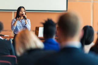 Safety professional woman with blue blouse presenting at a conference