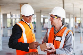 Two safety professional men in PPE on a job site