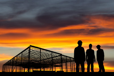 Workers on a Construction Site at Sunset