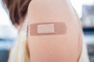 Woman wearing a bandage after vaccination