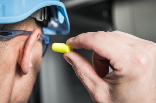 Worker putting in an ear plug