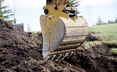 Close-up of construction equipment digging ground