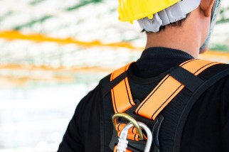 Worker wearing a fall protection harness