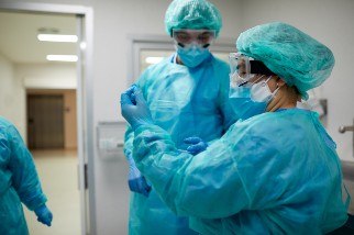 Healthcare workers donning PPE