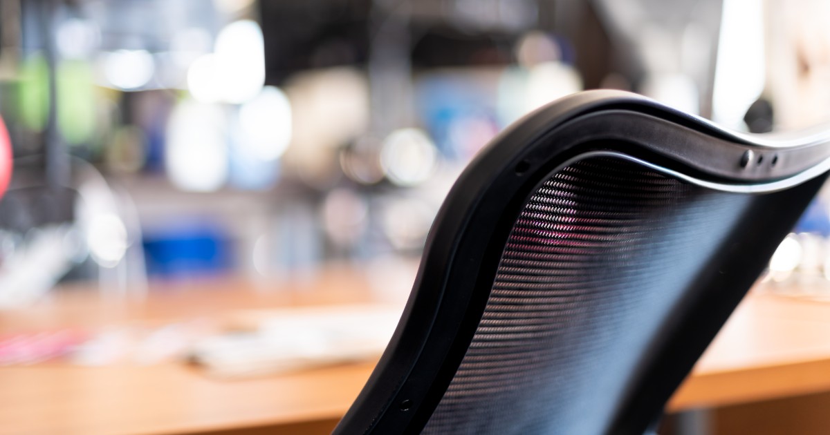 Closeup of a black ergonomic chair in a home workspace