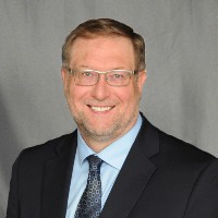 Professional headshot of Greg Zigulis