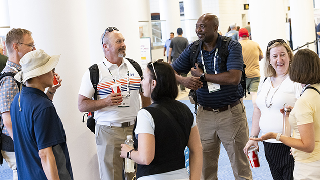 Photo of a group of attendees at an ASSP event talking to each other